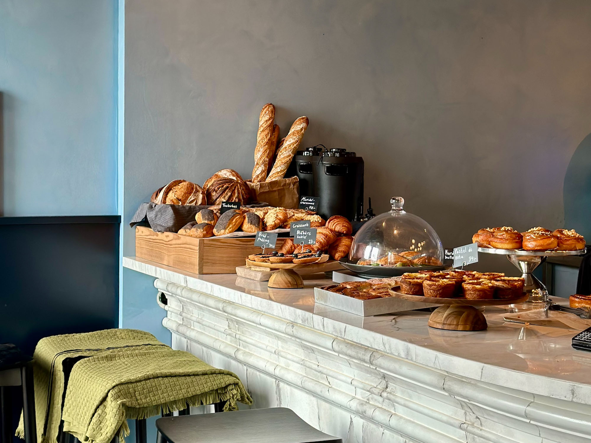 A bar counter with bread and buns at Röda Rummet in Gothenburg.