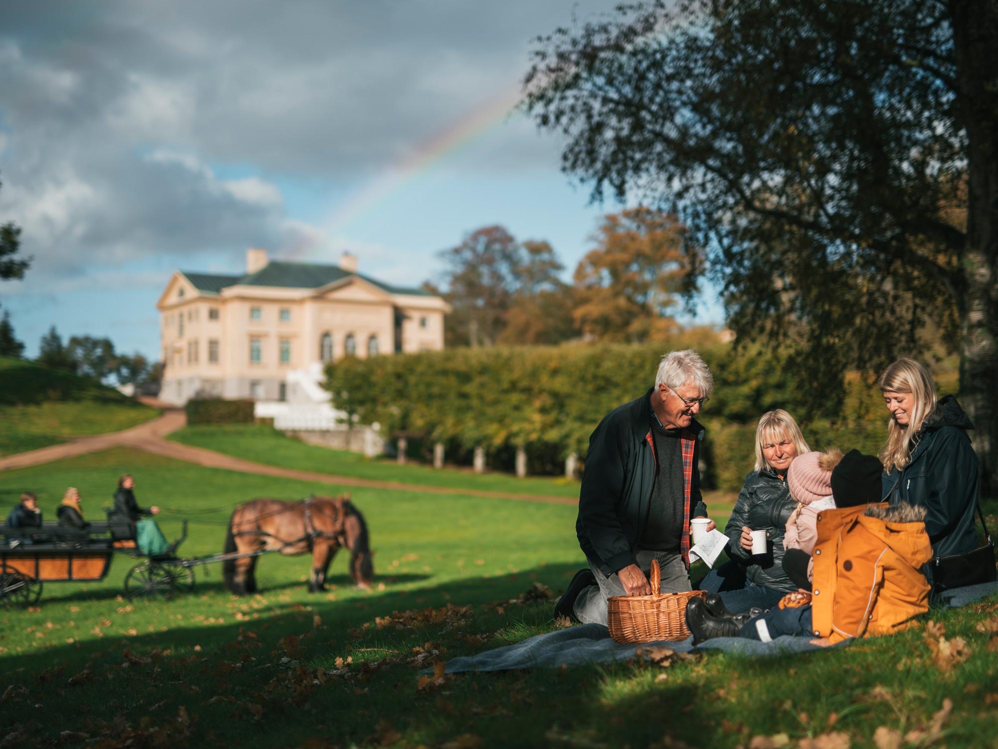 A family having picnic in the garden of Gunnebo Castle outside Gothenburg.