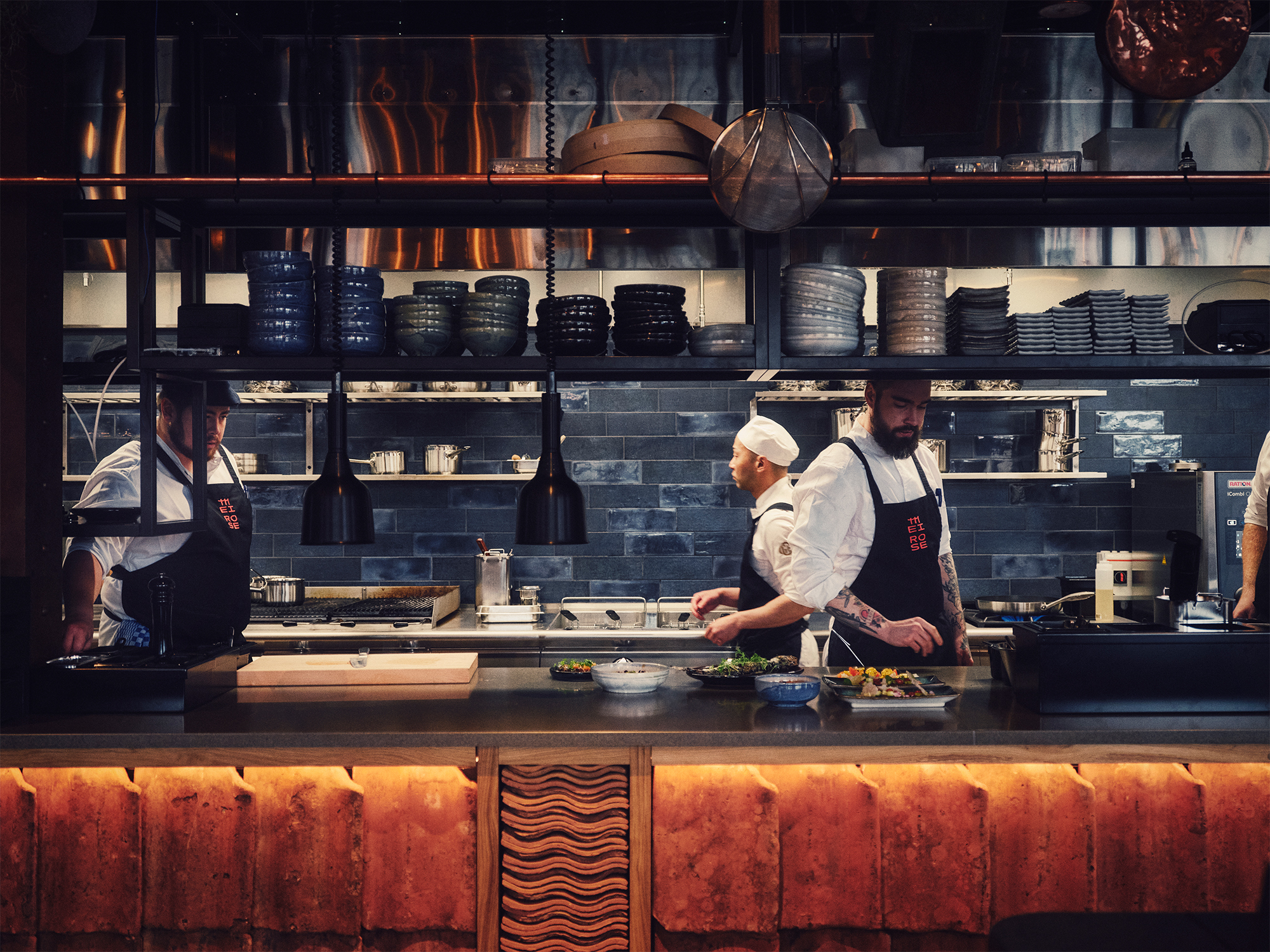Chefs working in the open kitchen at Mei Rose restaurant in Gothenburg, Sweden.